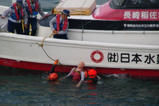 要救助者を船上にあげる潜水士